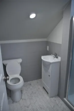 a bathroom with a toilet sink and mirror