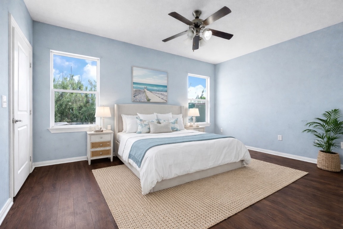 771 10th Street Dickinson, TX 77539 - Photo 13 of 24 a bedroom with a large bed chandelier and a window