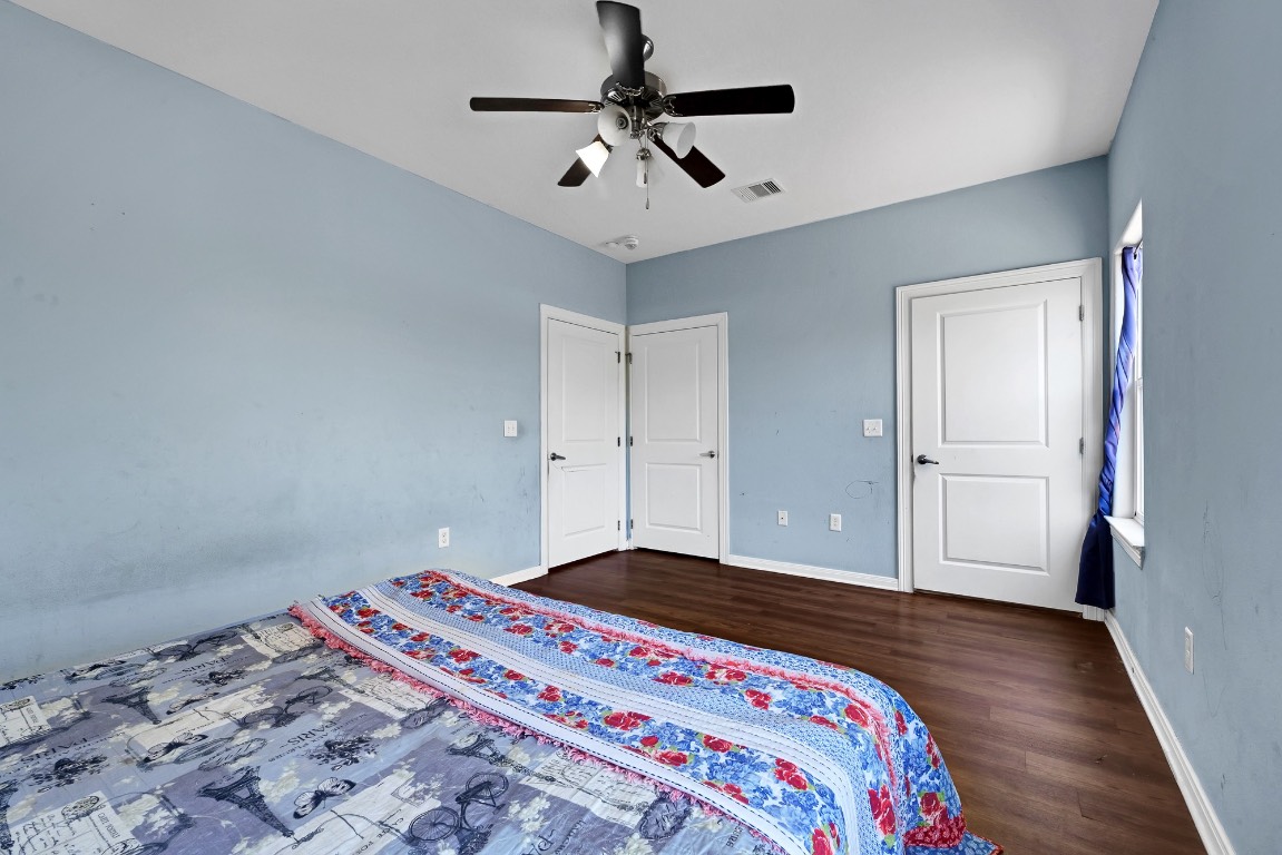 771 10th Street Dickinson, TX 77539 - Photo 14 of 24 a bedroom with a bed and a chandelier