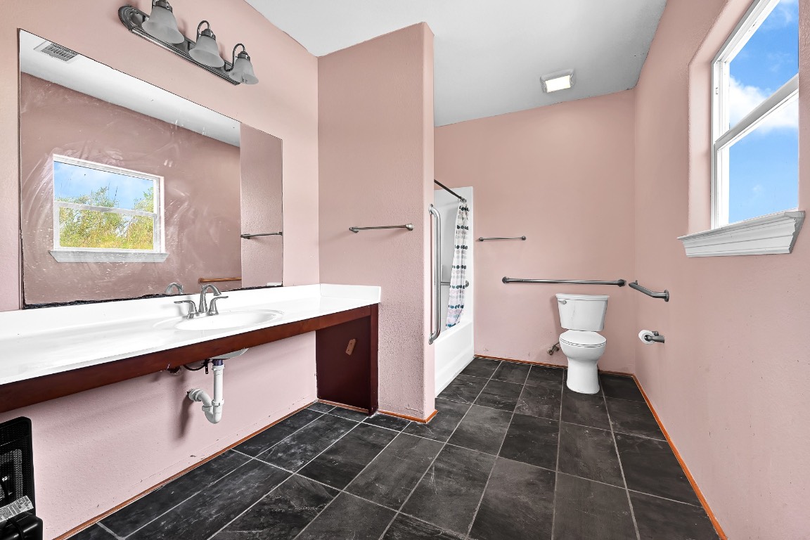 771 10th Street Dickinson, TX 77539 - Photo 16 of 24 a bathroom with a sink and a mirror