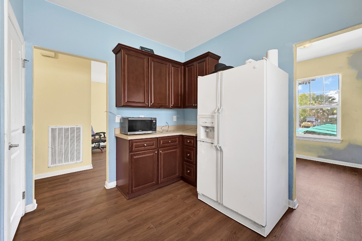 771 10th Street Dickinson, TX 77539 - Photo 6 of 24 a kitchen with a refrigerator sink and cabinets
