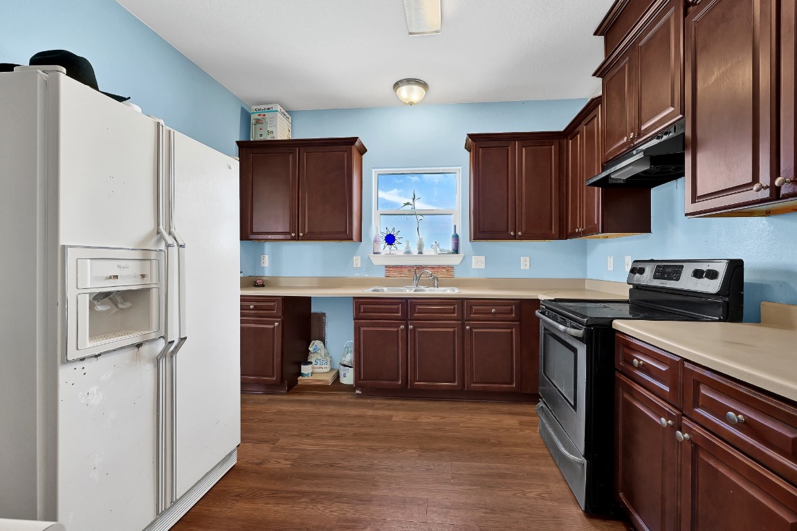 771 10th Street Dickinson, TX 77539 - Photo 7 of 24 a kitchen with stainless steel appliances granite countertop a refrigerator stove top oven and sink