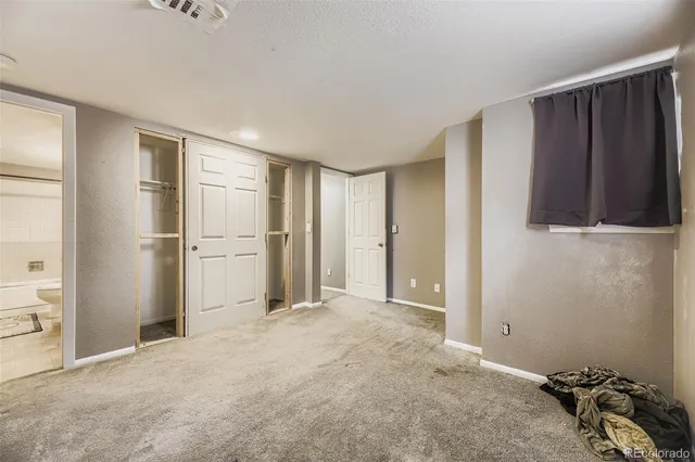 a view of empty room with closet and wooden floor