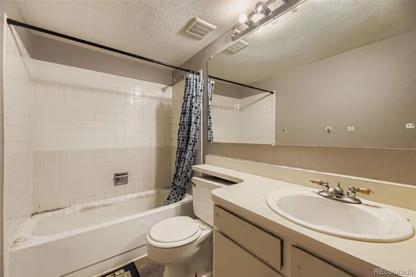 a bathroom with a sink toilet tub and shower