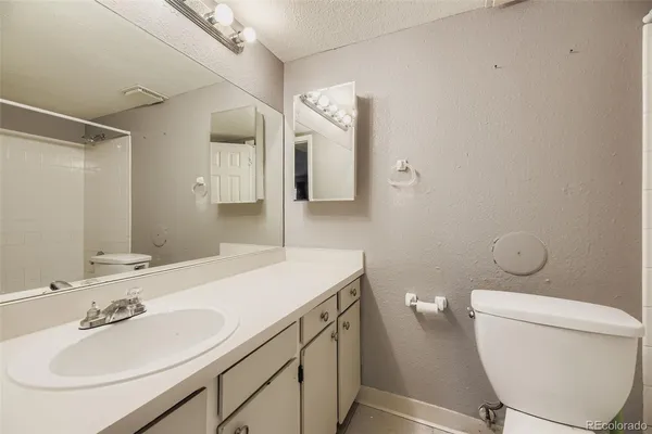 a bathroom with a sink toilet and mirror