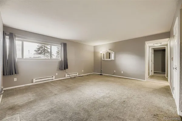 an empty room with windows and closet