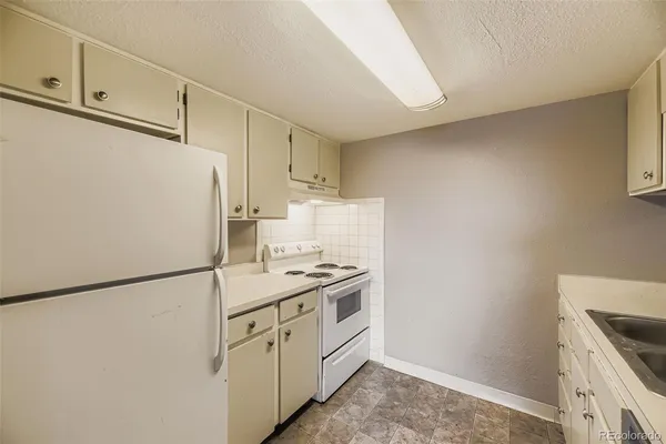 a kitchen with a white cabinets and white appliances