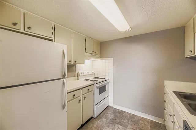 a kitchen with a white cabinets and white appliances