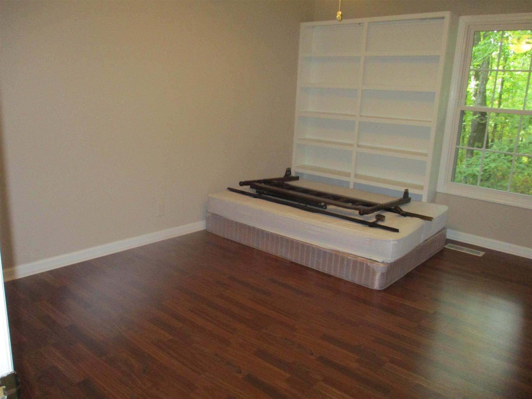 1073 West Point Road Lawrenceburg, TN 38464 - Photo 22 of 24 a room with wooden floor and a window