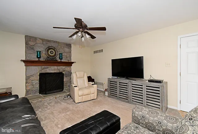 a view of a dining room with furniture and a chandelier