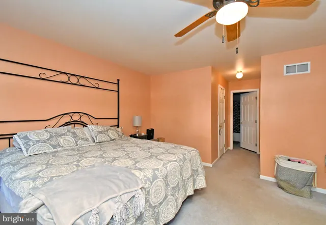 a bedroom with a bed and a dresser in it