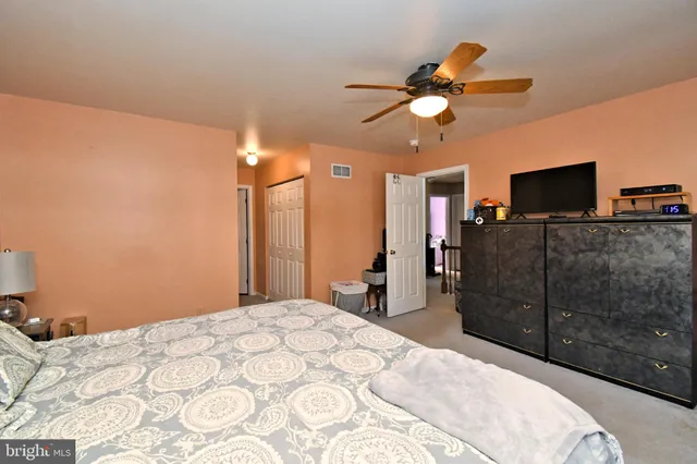 a bedroom with a bed and a dresser