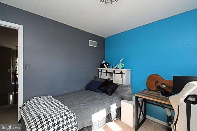 a bathroom with a granite countertop sink mirror vanity and toilet