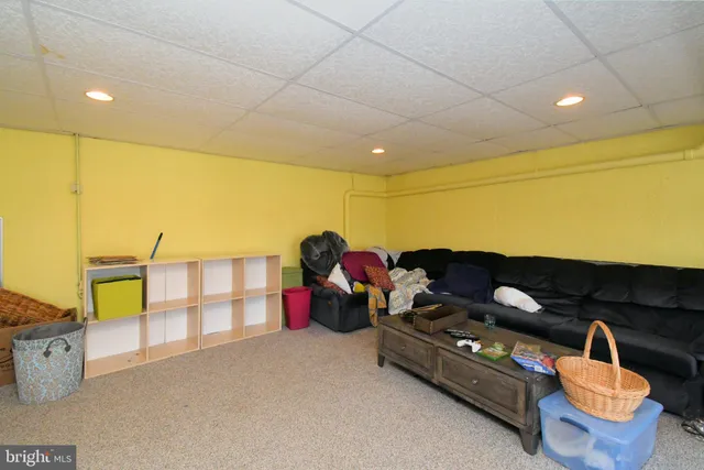 a view of a backyard with table and chairs a fire pit and grass
