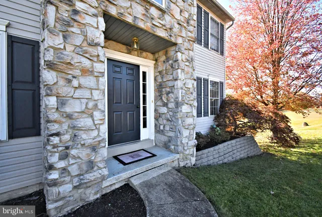 a kitchen with stainless steel appliances granite countertop a sink stove refrigerator and microwave