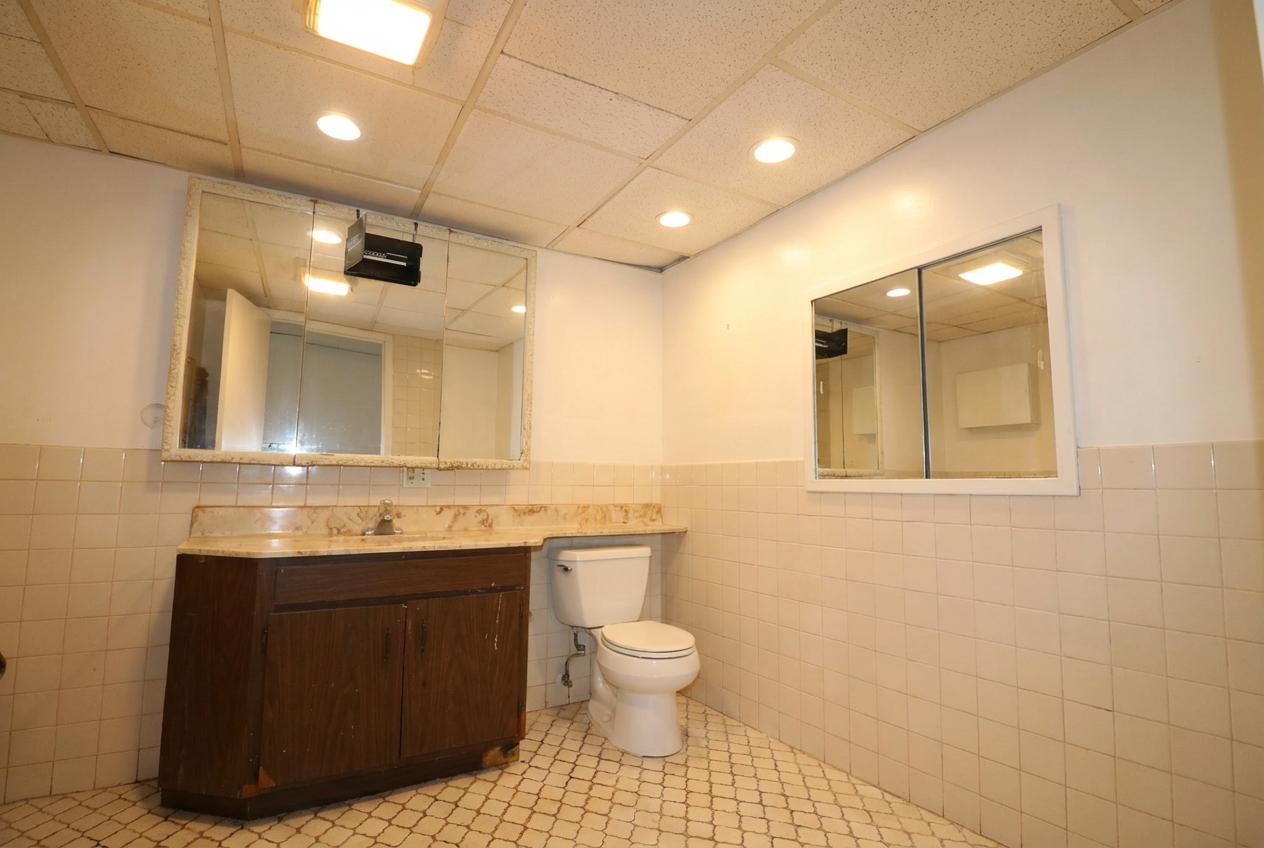 45 North McAree Road Waukegan, IL 60085 - Photo 6 of 12 a bathroom with a sink a toilet and a mirror