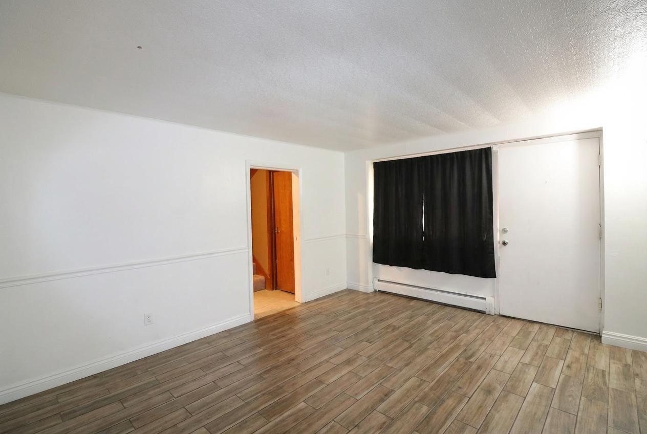 45 North McAree Road Waukegan, IL 60085 - Photo 10 of 12 an empty room with wooden floor and windows