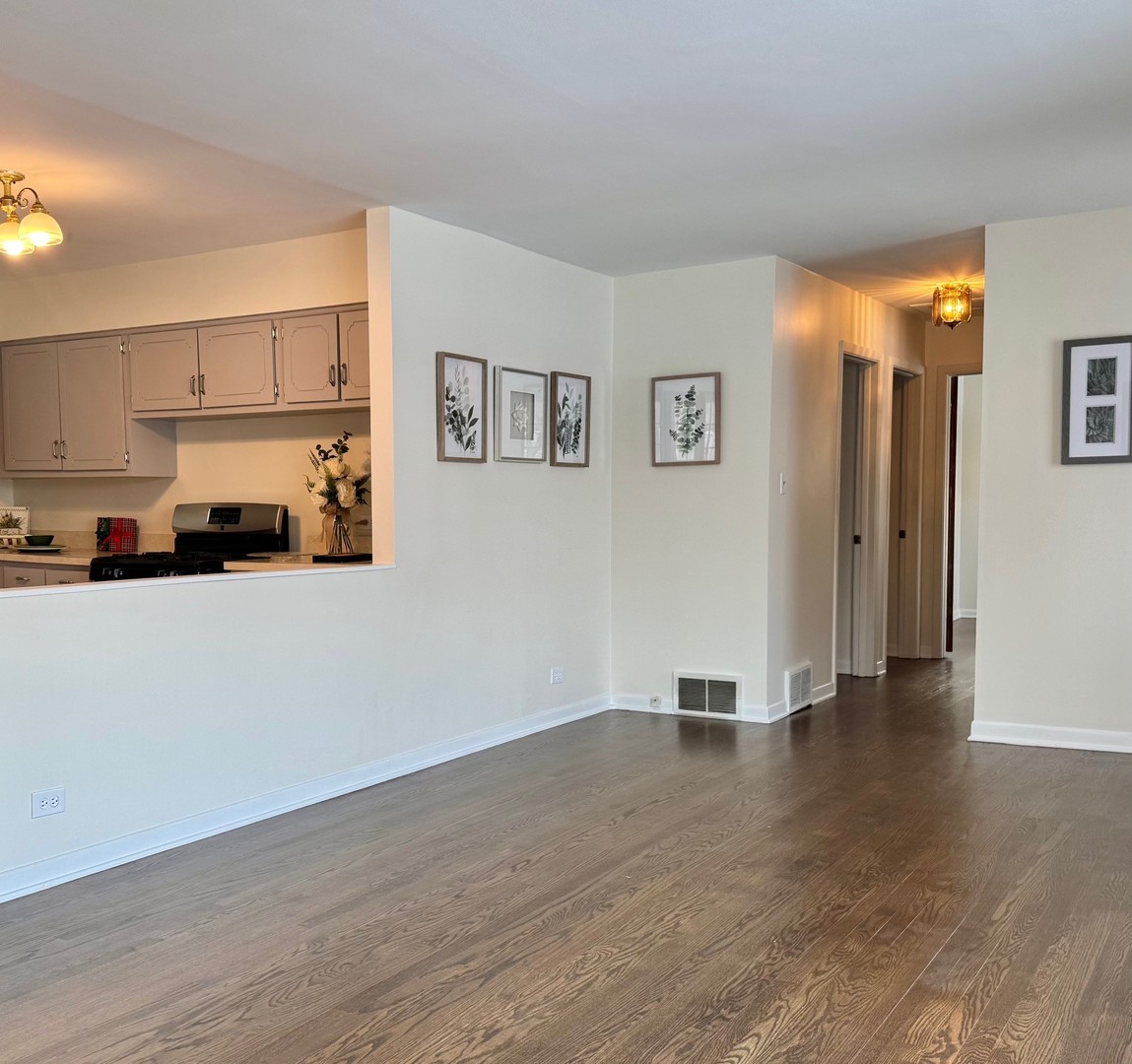 3051 South Scott Street Des Plaines, IL 60018 - Photo 8 of 43 a view of an empty room with wooden floor and a window