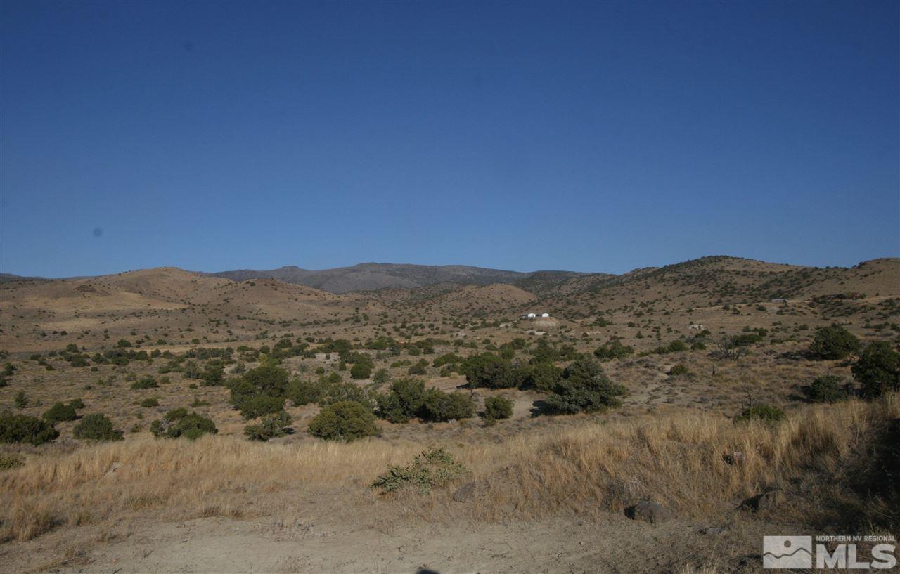 355 Hidden Canyon Road Reno, NV 89510 - Photo 1 of 7 a view of a dry yard with mountains in the background