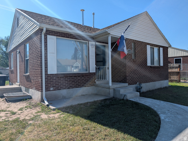 2880 Merton Way Magna, UT 84044 - Photo 1 of 30 Brick exterior featuring white siding gables and a covered front porch