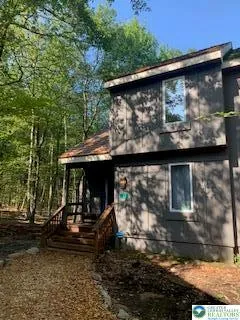 a view of a car park in front of a house