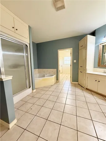 a bedroom with a bed and ceiling fan