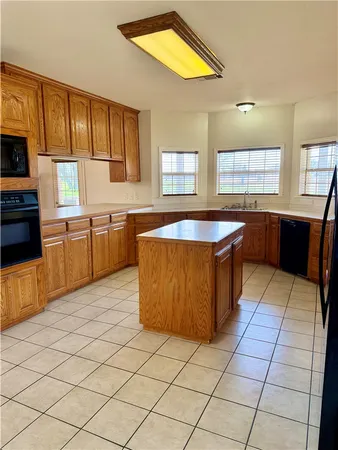a kitchen with stainless steel appliances granite countertop a sink counter space cabinets and a window