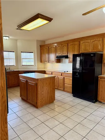 a kitchen with stainless steel appliances a sink and a refrigerator
