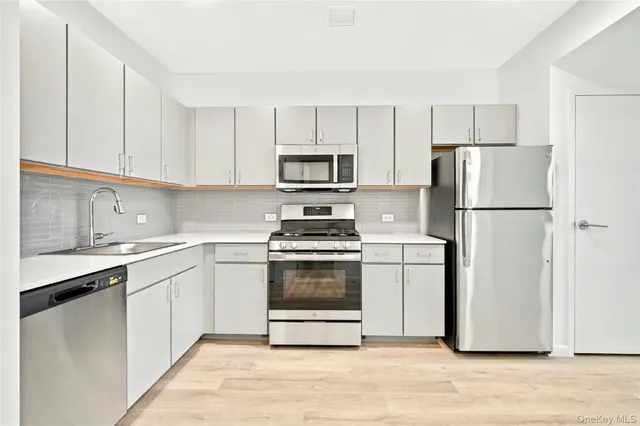 a kitchen with a stove a microwave and refrigerator