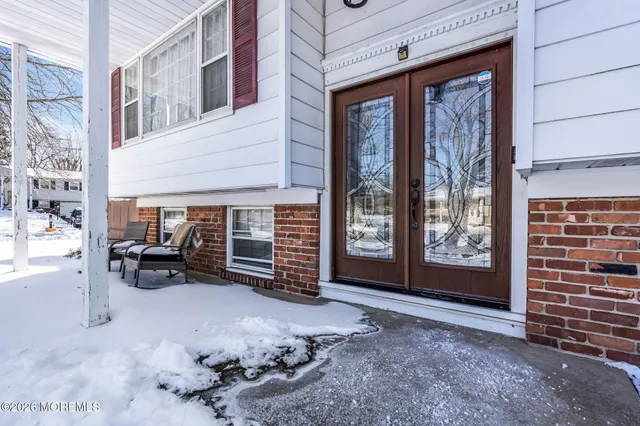 a view of a room with furniture and next to a window