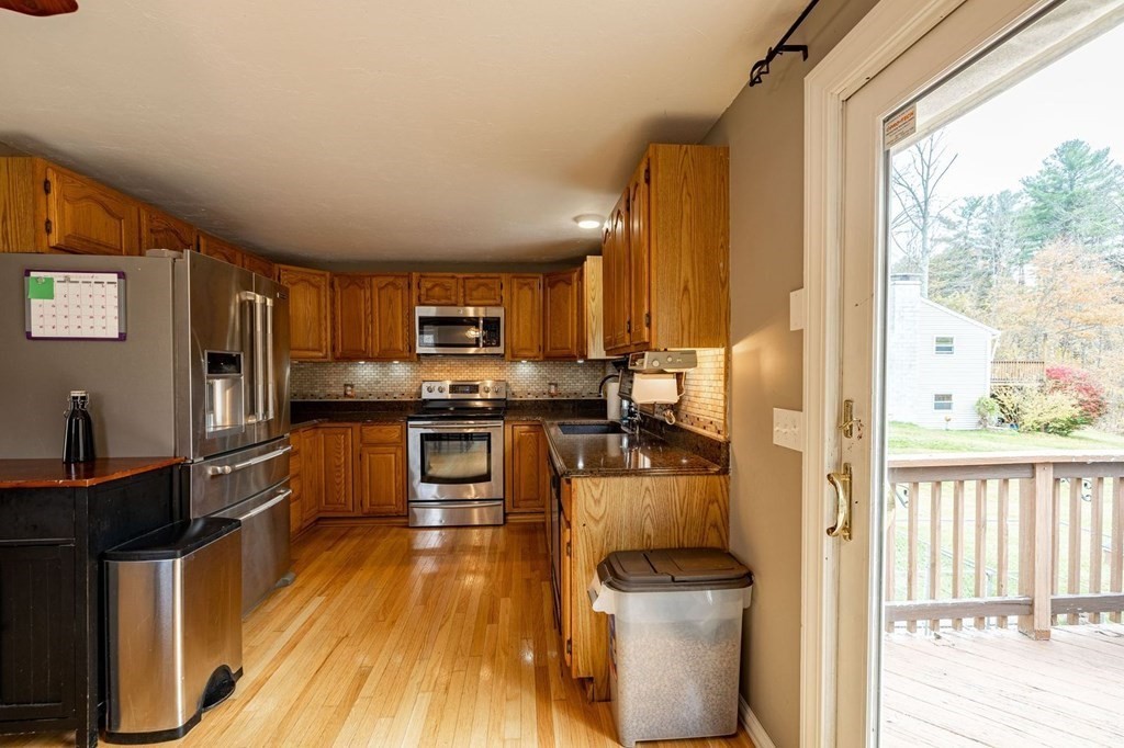 198 Lower Gore Road Webster, MA 01570 - Photo 12 of 41 a kitchen with stainless steel appliances a stove top oven a sink and a refrigerator