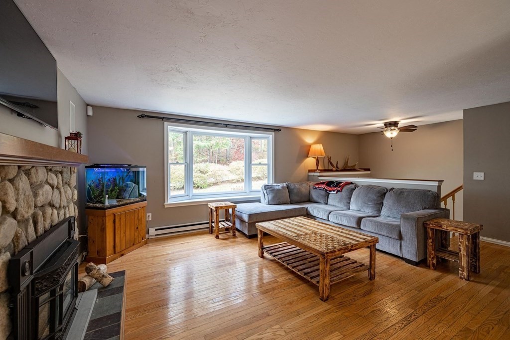 198 Lower Gore Road Webster, MA 01570 - Photo 13 of 41 a living room with furniture and a flat screen tv
