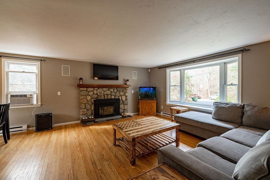 198 Lower Gore Road Webster, MA 01570 - Photo 16 of 41 a living room with furniture a fireplace and a flat screen tv