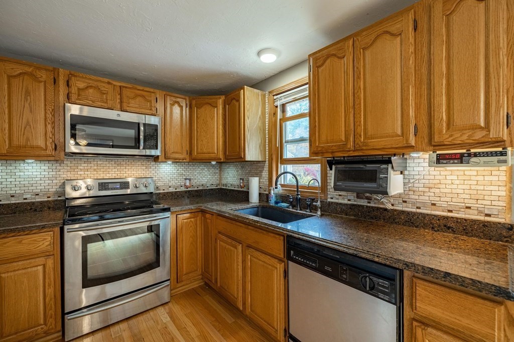 198 Lower Gore Road Webster, MA 01570 - Photo 10 of 41 a kitchen with granite countertop a stove sink and microwave