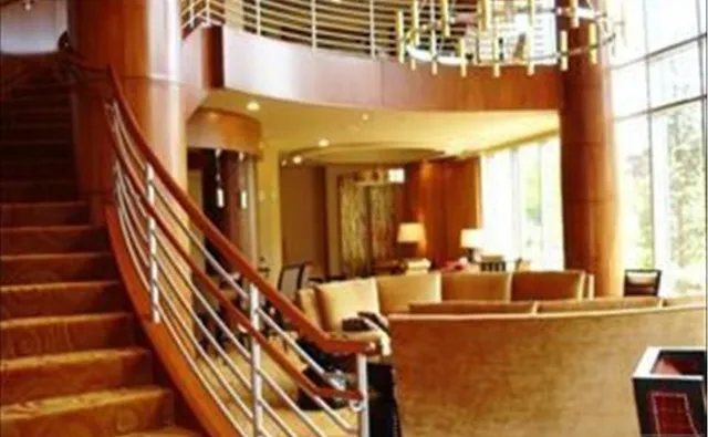 a view of a living room with furniture and stairs