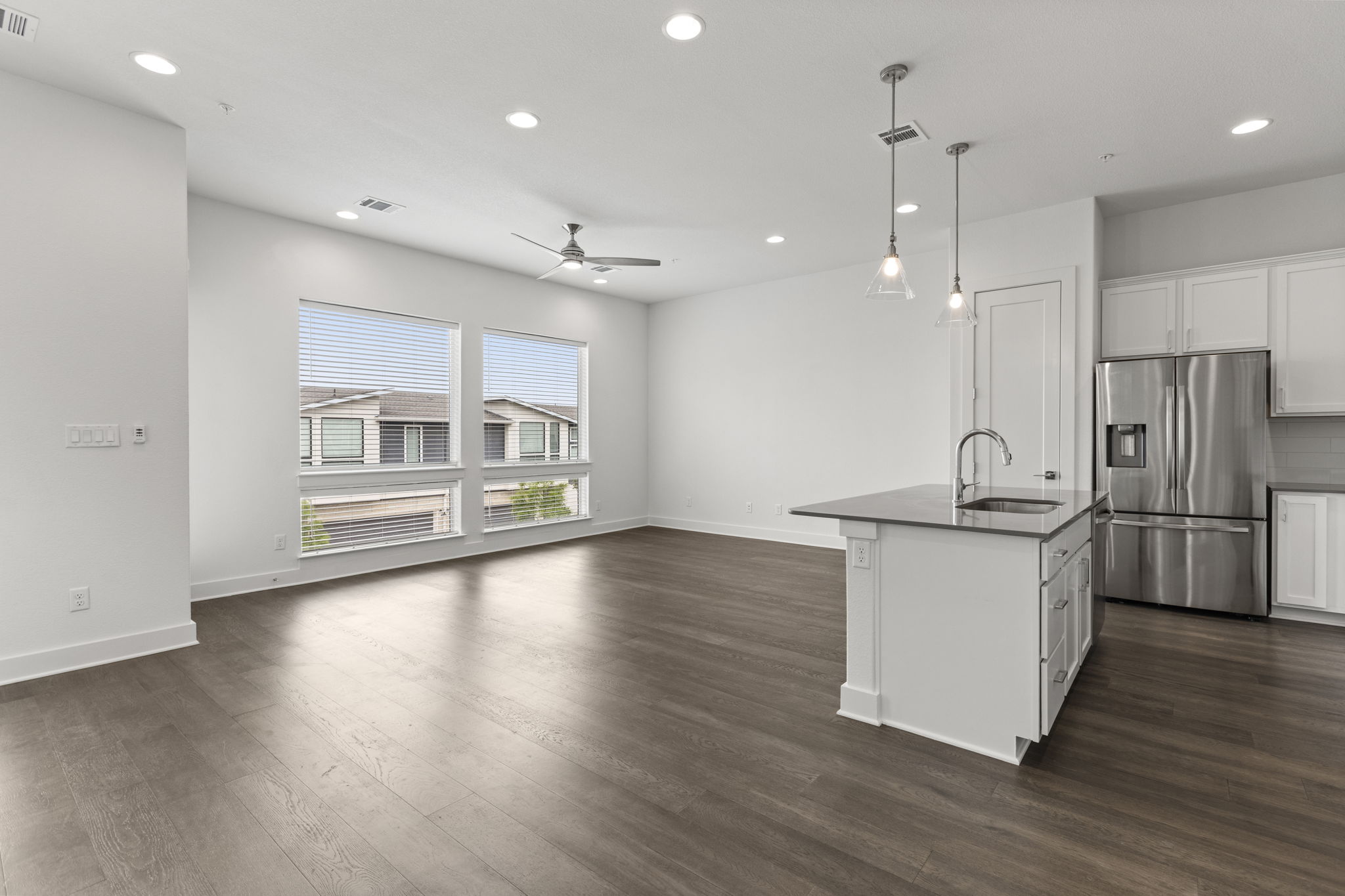 2050 Lohmans Spur Road, Unit 2005 Lakeway, TX 78734 - Photo 31 of 36 =2050 Lohmans Spur #2005 - the main floor has an open floorplan with modern kitchen, large living and dining area, and an outdoor balcony.