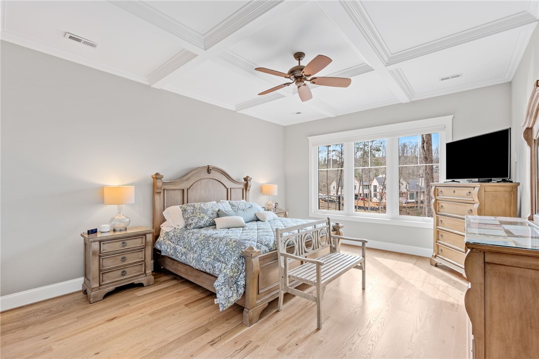827 Top Ridge Drive Sunset, SC 29685 - Photo 18 of 44 This spacious primary bedroom features rich hardwood floors and abundant natural light.