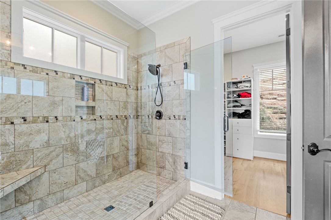 827 Top Ridge Drive Sunset, SC 29685 - Photo 21 of 44 This spacious bathroom offers a glass-enclosed shower and an adjacent walk-in closet.