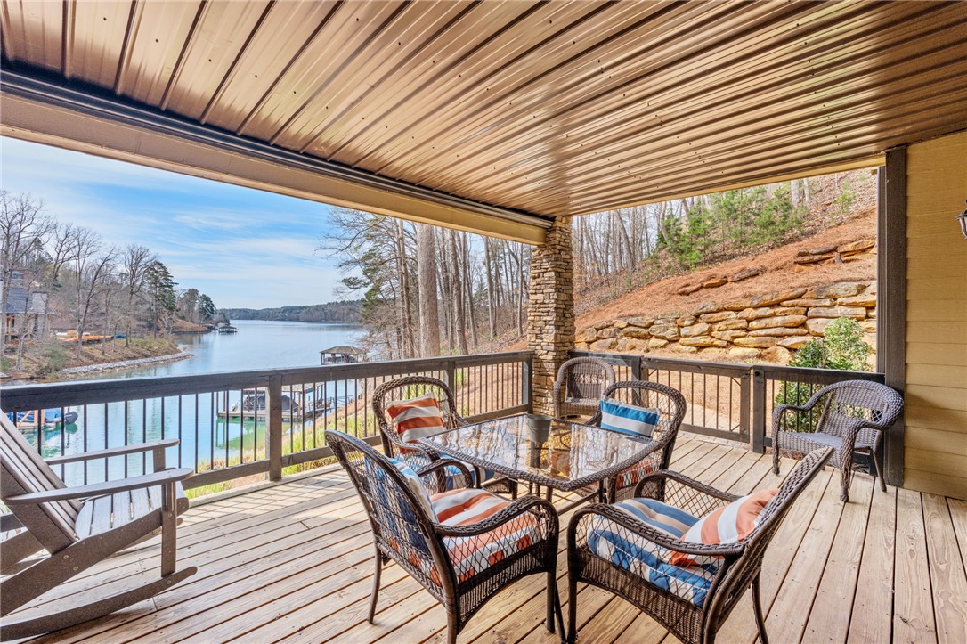 827 Top Ridge Drive Sunset, SC 29685 - Photo 30 of 44 This inviting covered deck offers serene waterfront views, ideal for relaxation and quick dock access.
