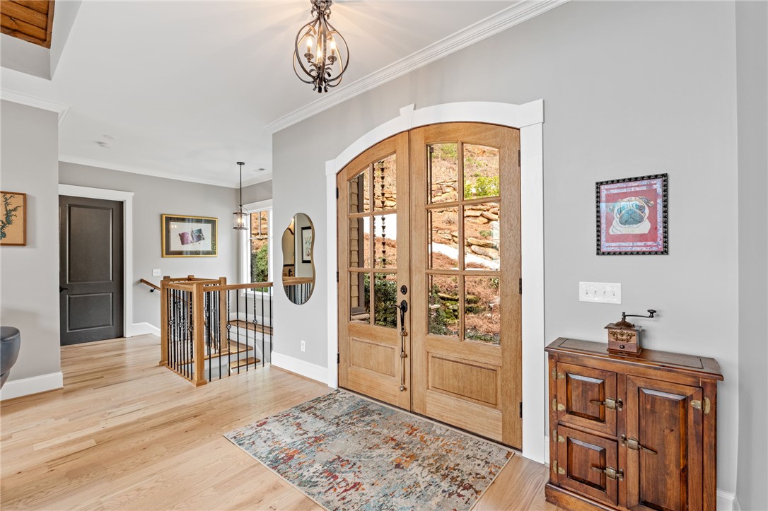 827 Top Ridge Drive Sunset, SC 29685 - Photo 3 of 44 Step into this inviting entrance, where natural light pours through charming glass-paneled double doors.