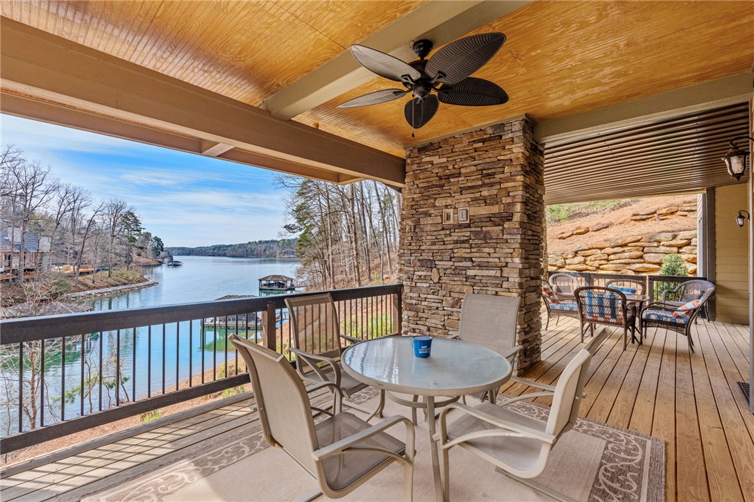 827 Top Ridge Drive Sunset, SC 29685 - Photo 31 of 44 Enjoy tranquil lake views from this expansive outdoor living space, perfect for relaxation and entertaining.