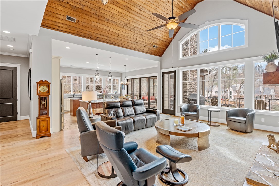 827 Top Ridge Drive Sunset, SC 29685 - Photo 7 of 44 This living room features expansive windows, a high vaulted ceiling, and rich hardwood flooring throughout.