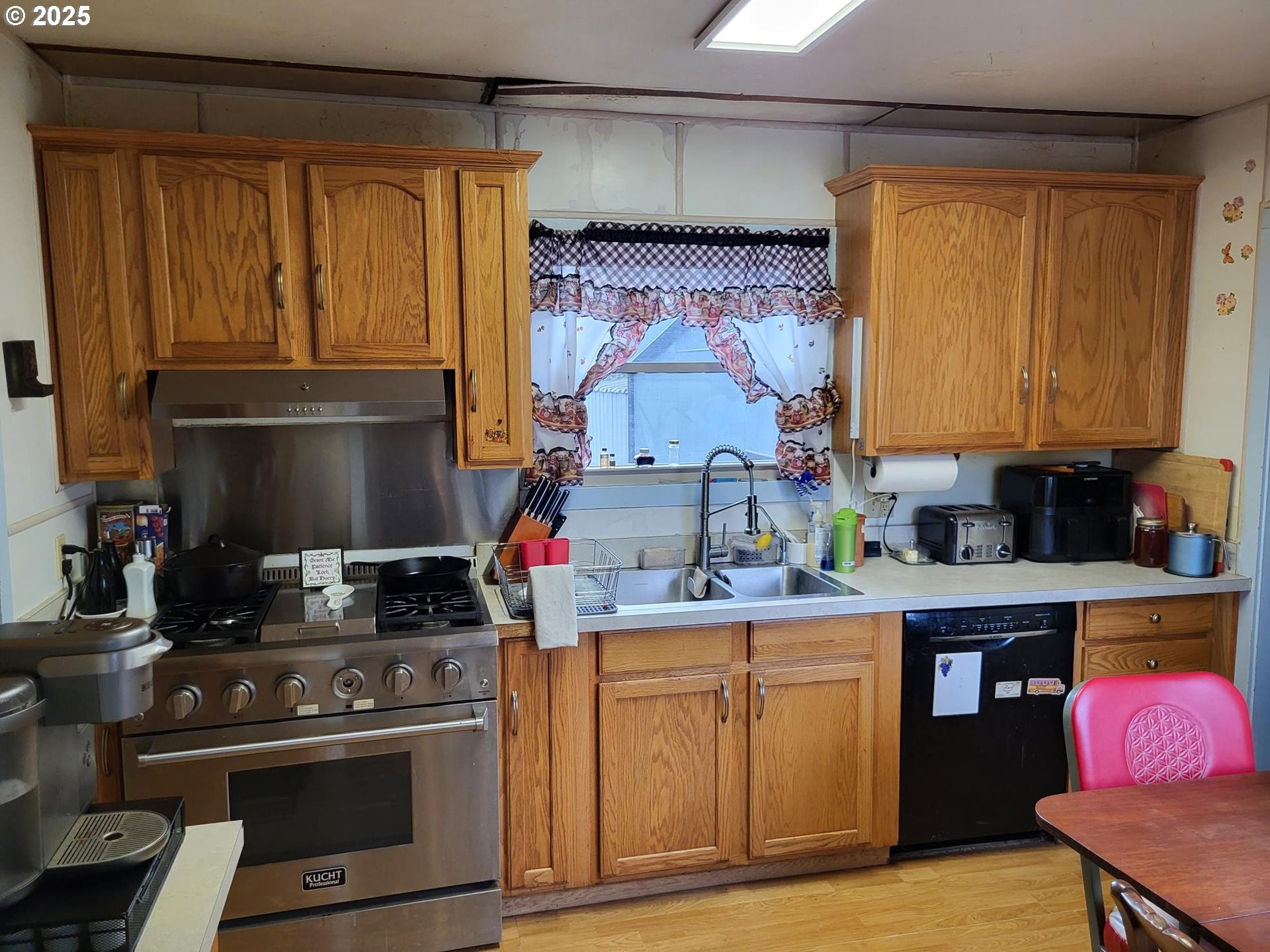 634 East Main Street Sheridan, OR 97378 - Photo 9 of 30 a kitchen with stainless steel appliances granite countertop a stove and a refrigerator