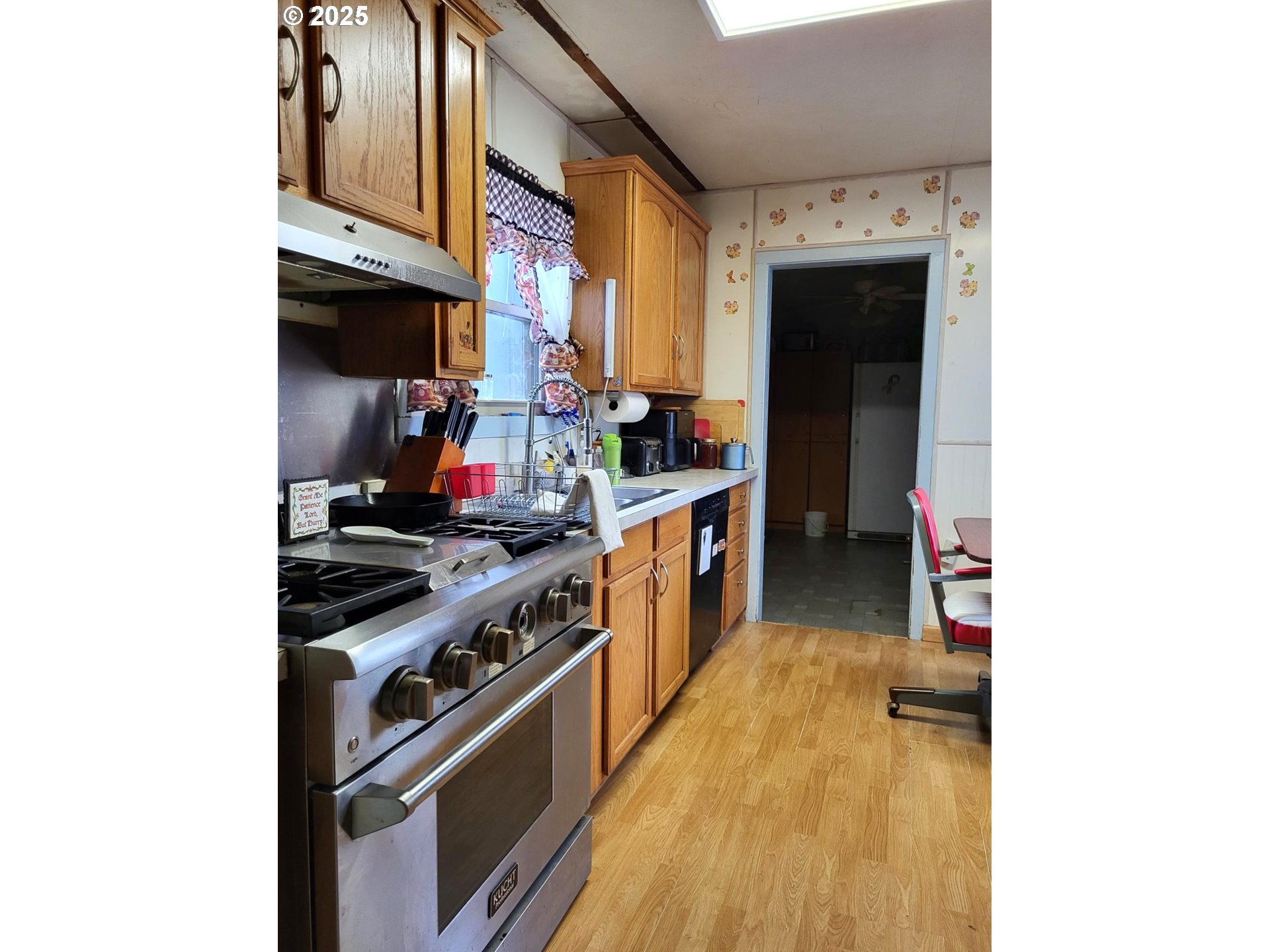 634 East Main Street Sheridan, OR 97378 - Photo 10 of 30 a kitchen with stainless steel appliances granite countertop a stove and a refrigerator
