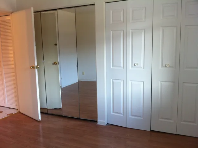 a view of an empty room with wooden floor