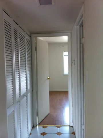 a view of a room with wooden floor