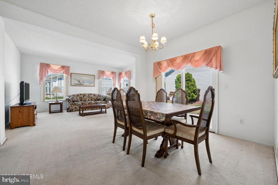 84 Chain Boulevard Bayville, NJ 08721 - Photo 12 of 39 a view of a dining room with furniture and a chandelier