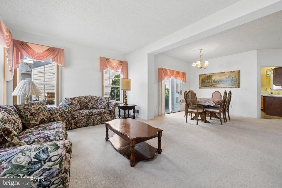 84 Chain Boulevard Bayville, NJ 08721 - Photo 15 of 39 a living room with furniture and a large window