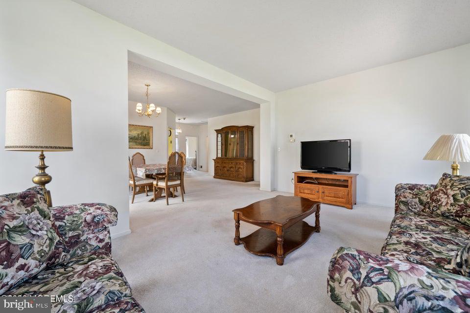 84 Chain Boulevard Bayville, NJ 08721 - Photo 16 of 39 a living room with furniture and a flat screen tv