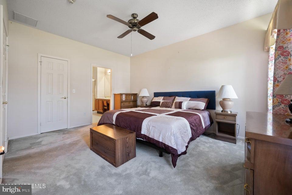 84 Chain Boulevard Bayville, NJ 08721 - Photo 22 of 39 a spacious bedroom with a bed and a chandelier